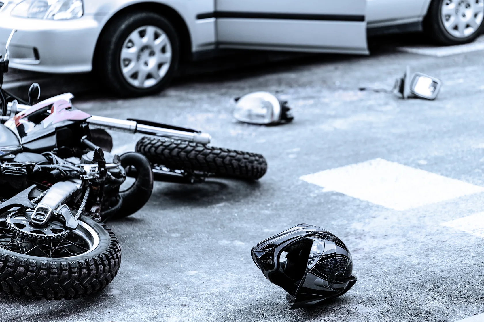 Scattered helmet and broken bike on street